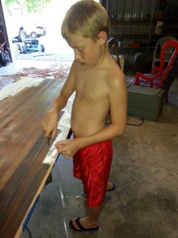 trimming epoxied cloth bottom.jpg